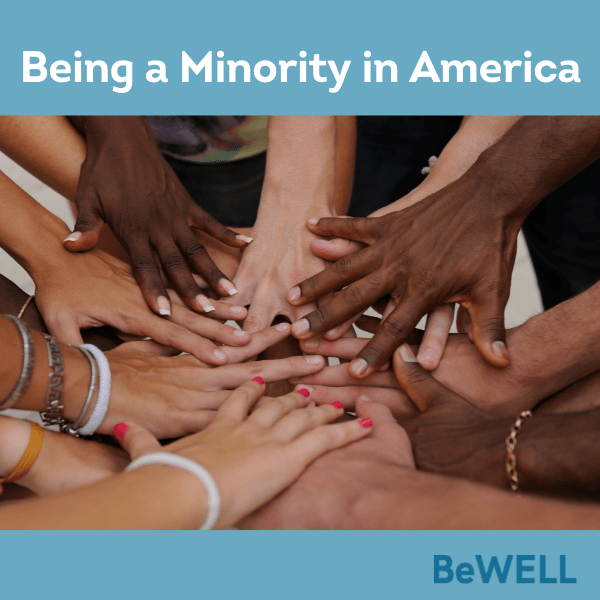 Image of hands coming together from diverse populations. image reads "Being a Minority in America"
